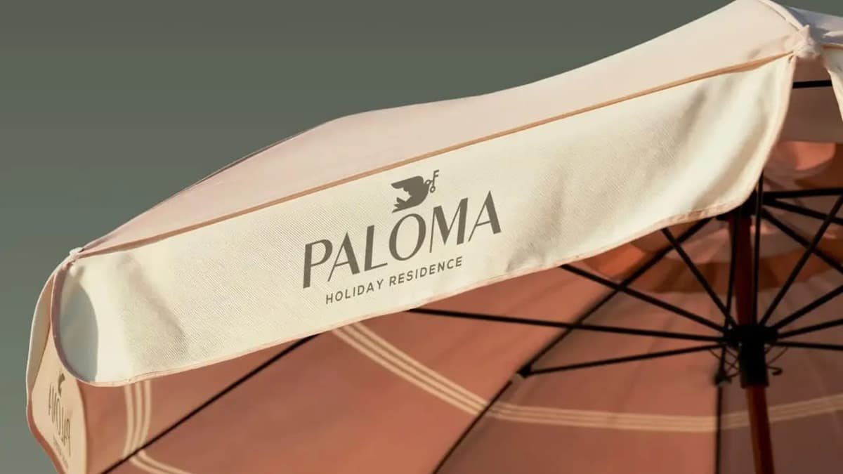 rosa sun umbrella with paloma logo on it